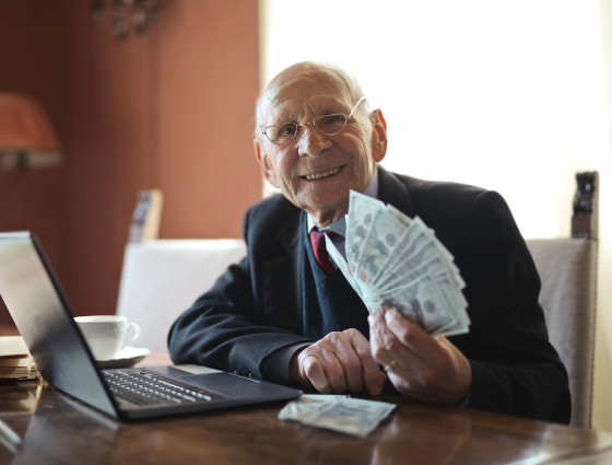An elderly gentleman holding cash.