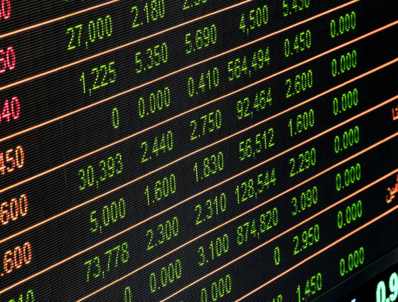 A stock exchange board, representing funding and investments.